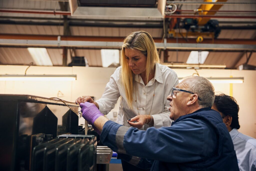 Erika Wilson Managing Director looking at the transformer with staff member